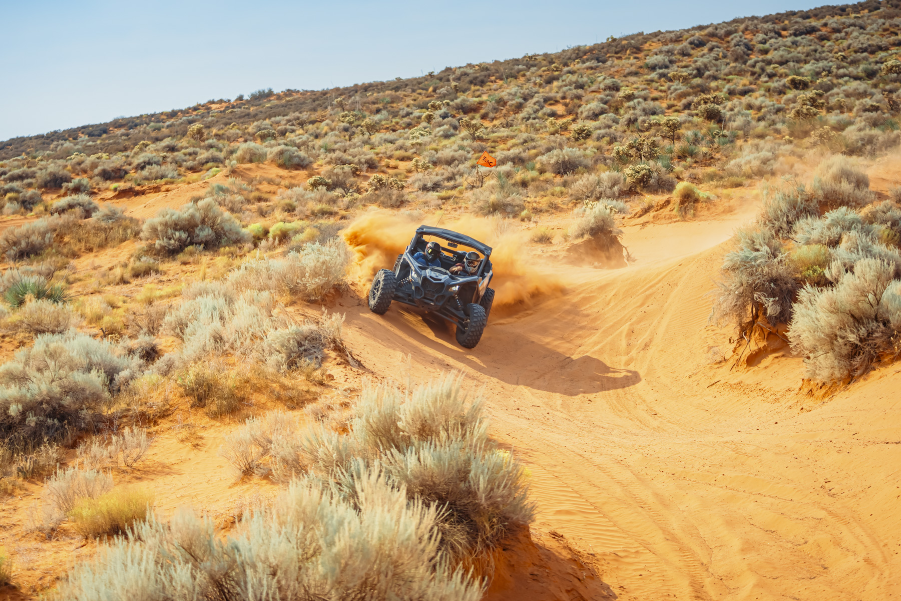 UTV speeding through sandy desert trails at Sand Hollow, Utah, near Zion and St. George, creating an exhilarating off-road experience.