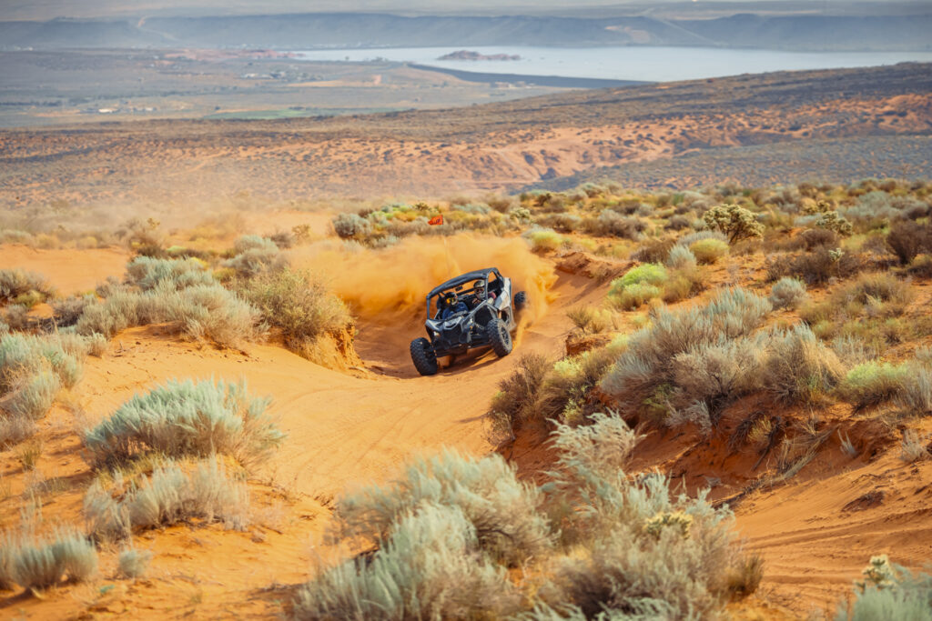 UTV driving through sandy trails with scenic views at Sand Hollow, Utah, near Zion and St. George, creating a thrilling off-road adventure.