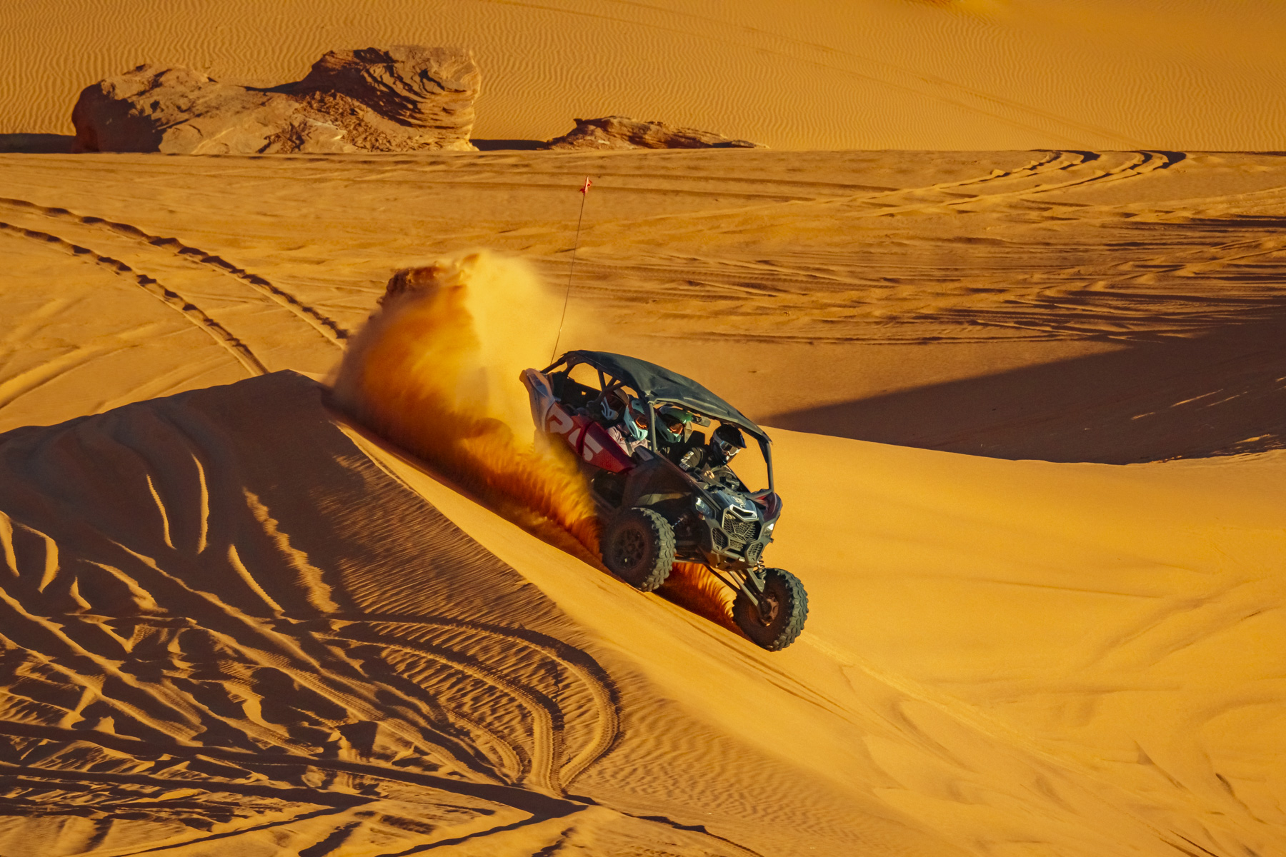 A UTV racing down a golden sand dune at Sand Hollow, capturing thrilling off-road adventures in Southern Utah’s dynamic landscape.